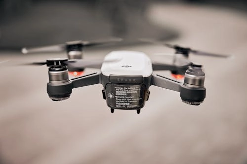 The image shows a DJI Spark drone hovering mid-air